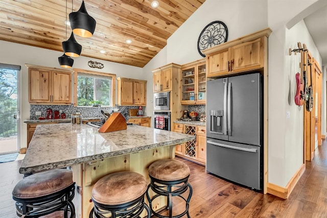 42596 Garnet Ln, Shaver Lake, CA 93664 - kitchen with decorative backsplash, glass insert cabinets, appliances with stainless steel finishes, wooden ceiling, and vaulted ceiling