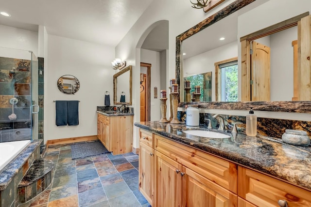 42596 Garnet Ln, Shaver Lake, CA 93664 - bathroom featuring a stall shower, a garden tub, stone finish floor, and a sink