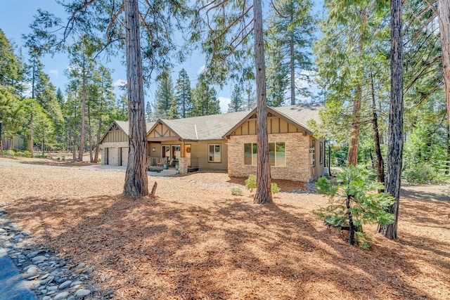 42596 Garnet Ln, Shaver Lake, CA 93664 - view of front facade featuring board and batten siding, stone siding, and a detached garage