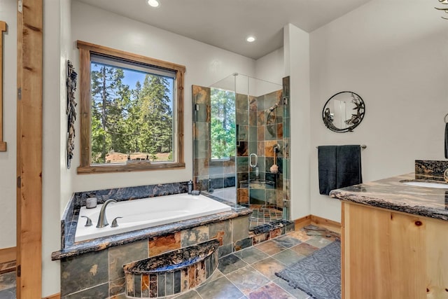 42596 Garnet Ln, Shaver Lake, CA 93664 - full bathroom with stone finish floor, a stall shower, baseboards, a garden tub, and vanity