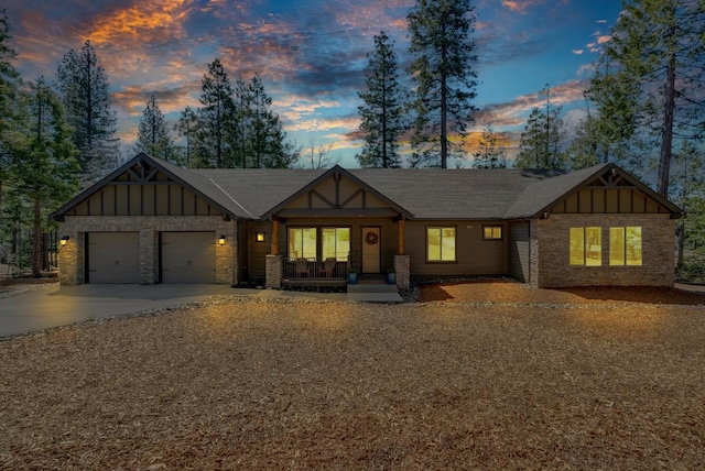 42596 Garnet Ln, Shaver Lake, CA 93664 - view of front of property featuring board and batten siding, a porch, a garage, and driveway