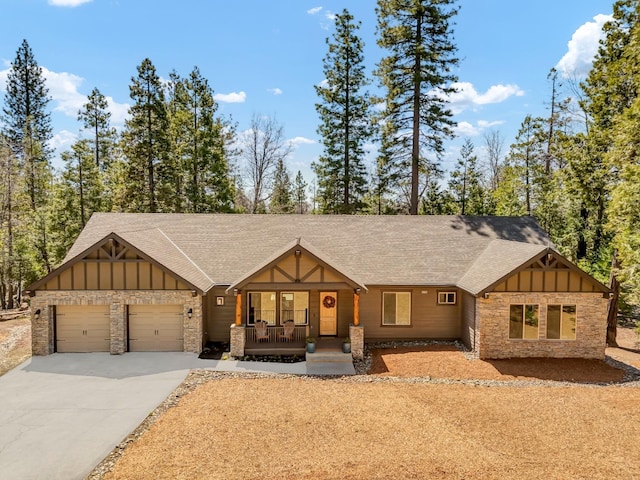 42596 Garnet Ln, Shaver Lake, CA 93664 - view of front of home with board and batten siding, a porch, roof with shingles, and concrete driveway