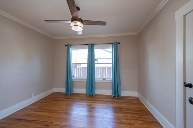 empty room featuring baseboards, wood finished floors, ceiling fan, and ornamental molding