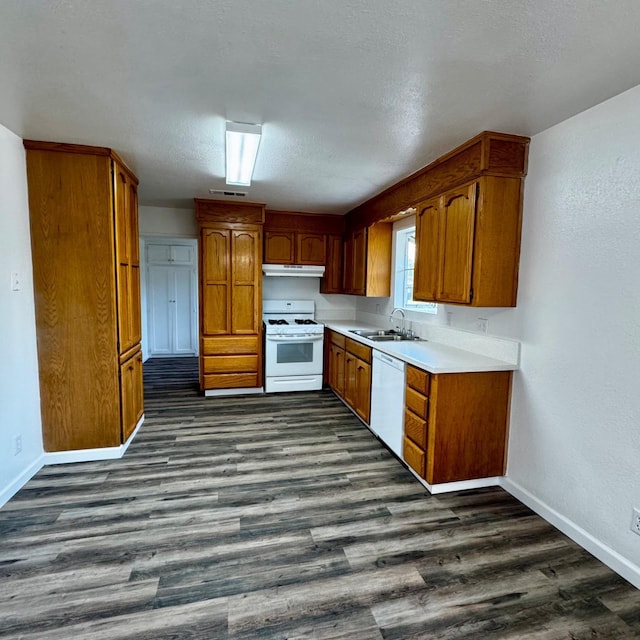 201 Walnut St, Madera, CA 93637 - kitchen with white appliances, baseboards, brown cabinets, a sink, and dark wood-style flooring