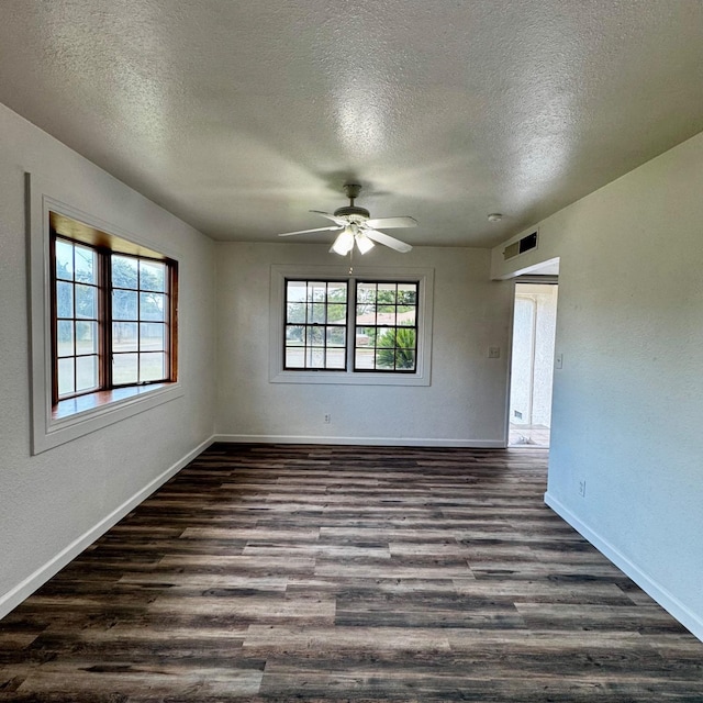 201 Walnut St, Madera, CA 93637 - unfurnished room featuring a textured ceiling, dark wood finished floors, a ceiling fan, and baseboards