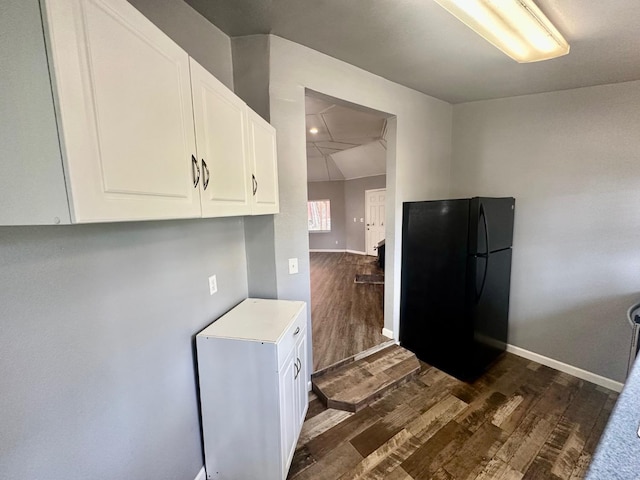41778 Muskrat Ln, Auberry, CA 93602 - kitchen with freestanding refrigerator, dark wood-type flooring, white cabinets, light countertops, and baseboards