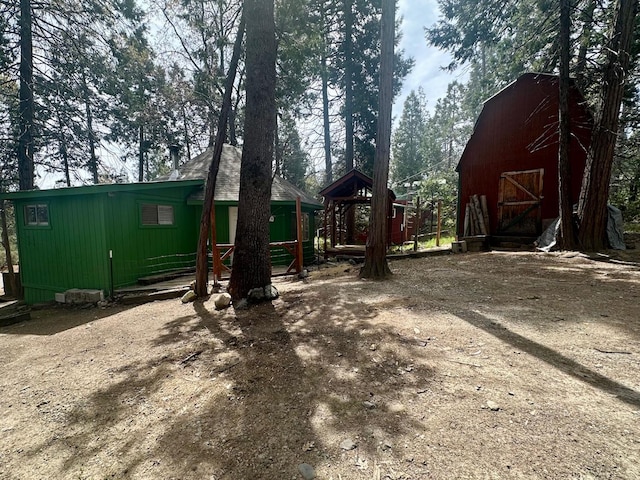 view of play area featuring an outdoor structure and a barn