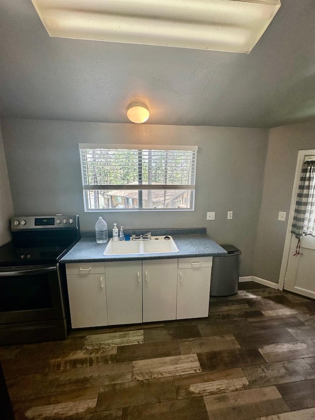 41778 Muskrat Ln, Auberry, CA 93602 - kitchen featuring stainless steel range with electric cooktop, dark wood finished floors, a sink, and white cabinets