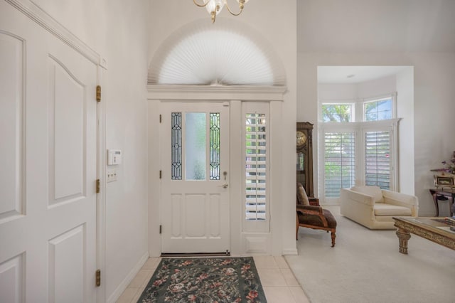 2727 W Bluff Ave Unit 136, Fresno, CA 93711 - entrance foyer with an inviting chandelier, light tile patterned floors, and baseboards