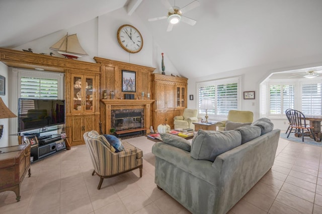 2727 W Bluff Ave Unit 136, Fresno, CA 93711 - living area featuring light tile patterned floors, ceiling fan, beam ceiling, a premium fireplace, and high vaulted ceiling