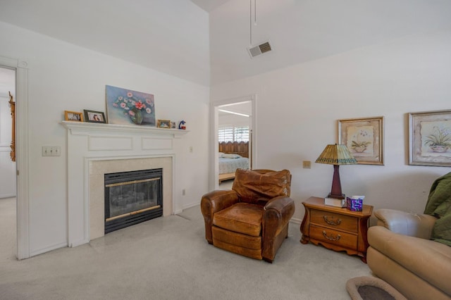 2727 W Bluff Ave Unit 136, Fresno, CA 93711 - carpeted living room featuring a fireplace with flush hearth, visible vents, and a high ceiling