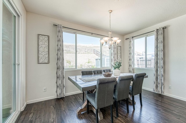 dining area with baseboards, an inviting chandelier, and dark wood-style flooring