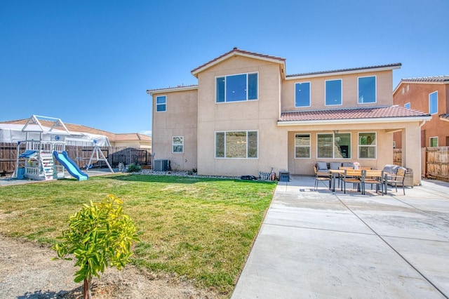 rear view of property with a tile roof, a patio area, a fenced backyard, outdoor lounge area, and stucco siding