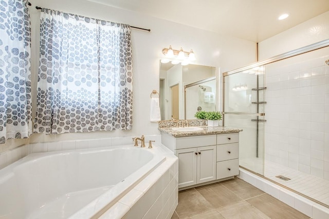 full bath with tile patterned floors, a garden tub, vanity, and a stall shower