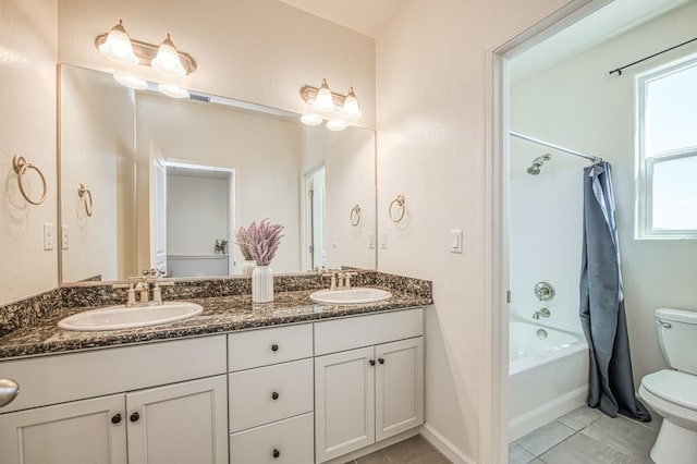 full bathroom featuring double vanity, shower / bath combo with shower curtain, toilet, and a sink