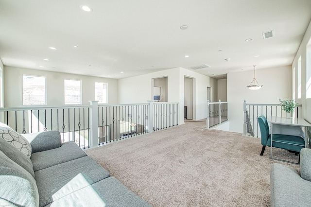 living area featuring visible vents, recessed lighting, and carpet flooring