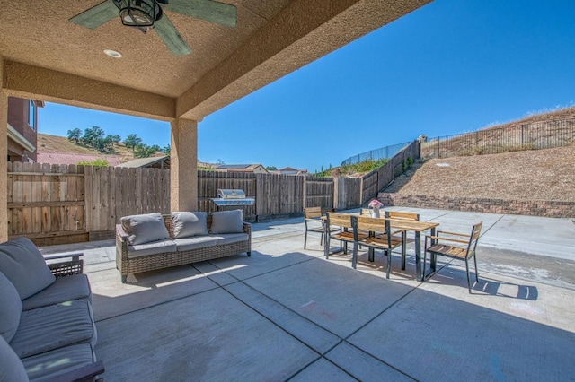 view of patio featuring outdoor dining space, ceiling fan, outdoor lounge area, and a fenced backyard