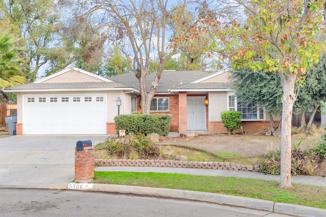 ranch-style house featuring a shingled roof, stucco siding, driveway, brick siding, and an attached garage