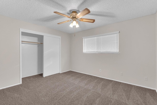 unfurnished bedroom featuring baseboards, a textured ceiling, a closet, and carpet flooring