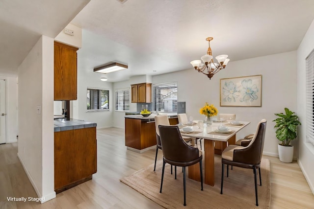 467 E Alluvial Ave Unit 106, Fresno, CA 93720 - dining area with light wood-style floors, a chandelier, and baseboards