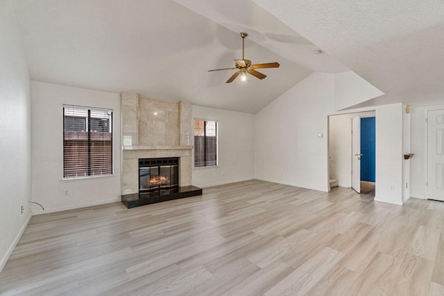 467 E Alluvial Ave Unit 106, Fresno, CA 93720 - unfurnished living room with ceiling fan, vaulted ceiling, light wood finished floors, a high end fireplace, and baseboards