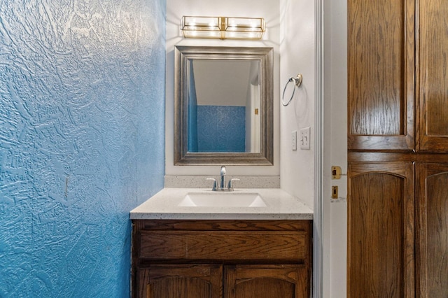 467 E Alluvial Ave Unit 106, Fresno, CA 93720 - bathroom featuring a textured wall and vanity