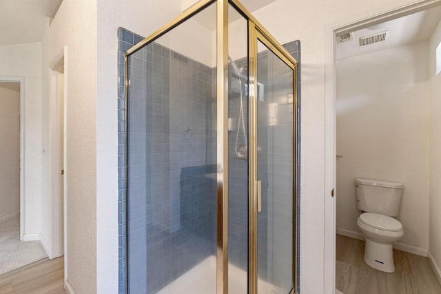 467 E Alluvial Ave Unit 106, Fresno, CA 93720 - bathroom featuring wood finished floors, a shower stall, toilet, and baseboards