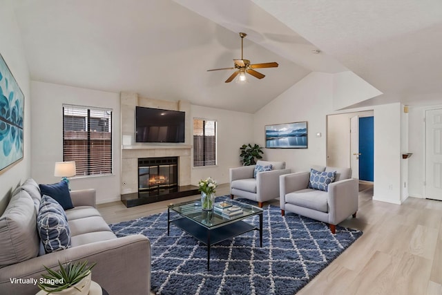 467 E Alluvial Ave Unit 106, Fresno, CA 93720 - living area with ceiling fan, wood finished floors, a fireplace, baseboards, and high vaulted ceiling