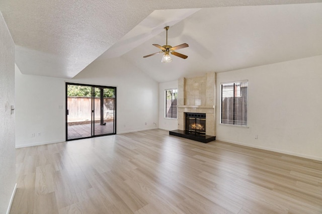 467 E Alluvial Ave Unit 106, Fresno, CA 93720 - unfurnished living room featuring a ceiling fan, light wood finished floors, a fireplace, lofted ceiling, and baseboards