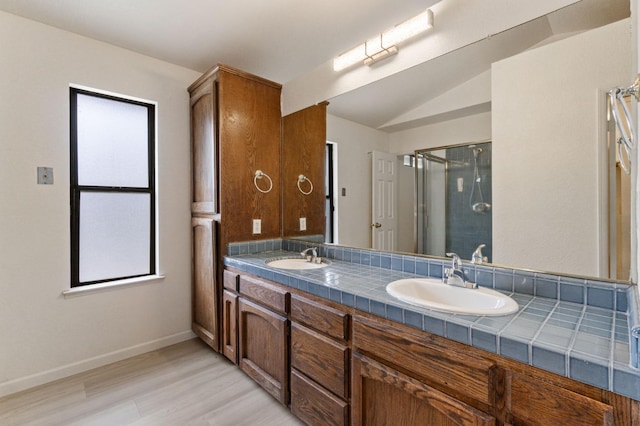 467 E Alluvial Ave Unit 106, Fresno, CA 93720 - full bath featuring wood finished floors, a stall shower, baseboards, double vanity, and vaulted ceiling