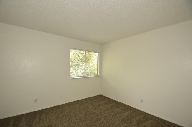 4765 N Cedar Ave Unit 105, Fresno, CA 93726 - empty room featuring dark carpet and baseboards