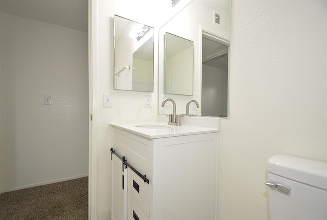 4765 N Cedar Ave Unit 105, Fresno, CA 93726 - half bath featuring vanity, toilet, and baseboards