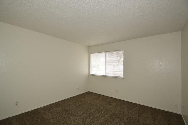 4765 N Cedar Ave Unit 105, Fresno, CA 93726 - unfurnished room featuring dark colored carpet, a textured ceiling, and baseboards