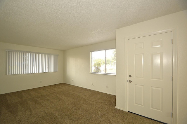 4765 N Cedar Ave Unit 105, Fresno, CA 93726 - spare room featuring carpet flooring, a textured ceiling, and baseboards