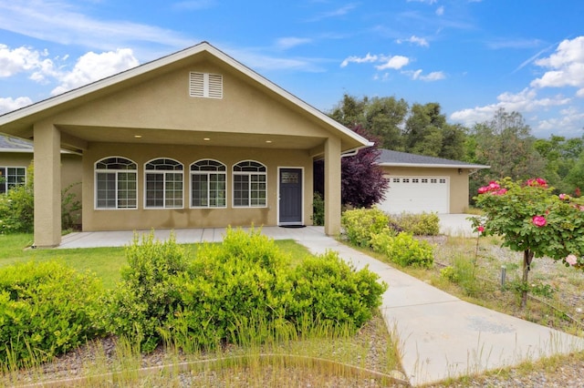 view of front of property with a garage and stucco siding
