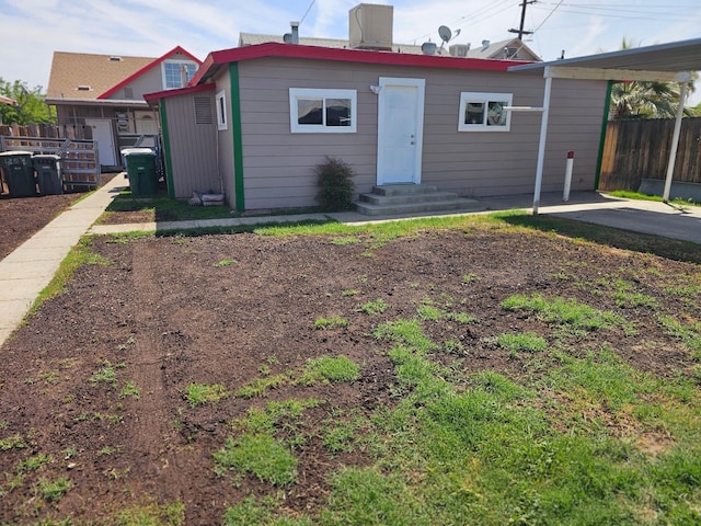 rear view of house with fence