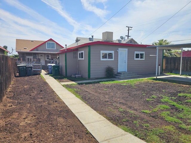 rear view of house with cooling unit and fence
