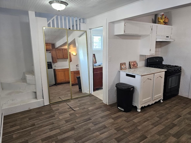 kitchen featuring black range with gas stovetop, stainless steel fridge with ice dispenser, dark wood finished floors, and under cabinet range hood