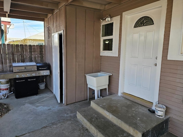 entrance to property with fence and a sink
