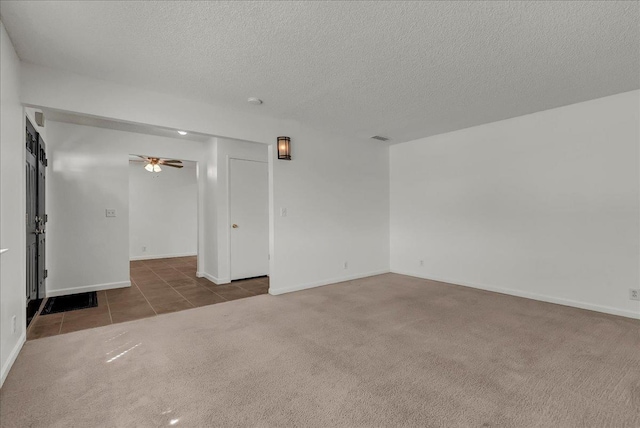 30 S Cambridge Dr, Lemoore, CA 93245 - tiled empty room featuring carpet floors, ceiling fan, a textured ceiling, and baseboards