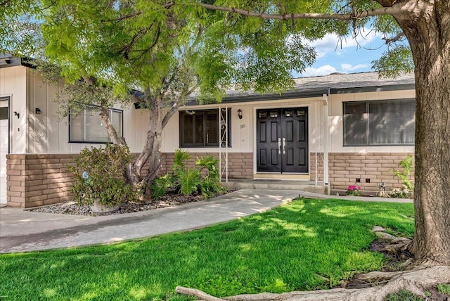 30 S Cambridge Dr, Lemoore, CA 93245 - property entrance featuring brick siding and a yard