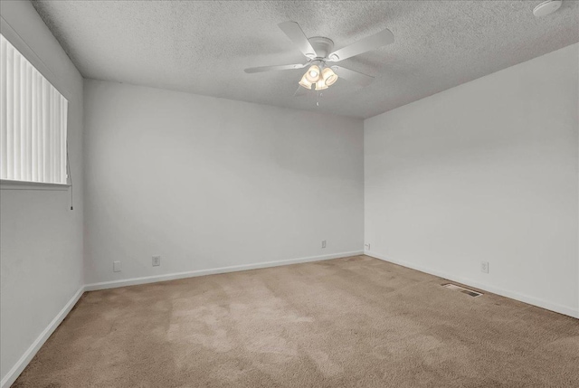 30 S Cambridge Dr, Lemoore, CA 93245 - empty room featuring carpet floors, a textured ceiling, a ceiling fan, and baseboards
