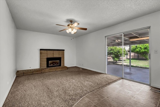 30 S Cambridge Dr, Lemoore, CA 93245 - unfurnished living room with baseboards, a textured ceiling, carpet flooring, ceiling fan, and a fireplace