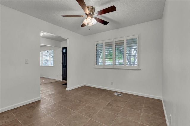 30 S Cambridge Dr, Lemoore, CA 93245 - unfurnished room featuring a textured ceiling, a ceiling fan, baseboards, and tile patterned floors