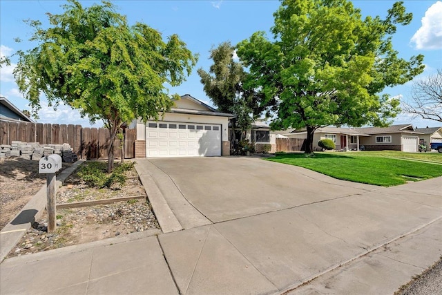30 S Cambridge Dr, Lemoore, CA 93245 - ranch-style home with concrete driveway, an attached garage, and brick siding