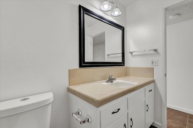 30 S Cambridge Dr, Lemoore, CA 93245 - half bath with vanity, toilet, tile patterned floors, and baseboards