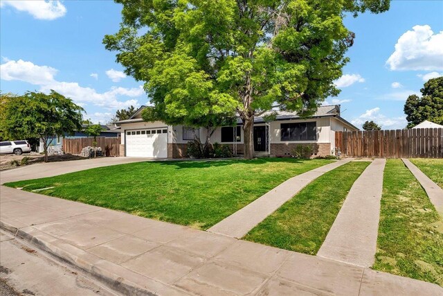 30 S Cambridge Dr, Lemoore, CA 93245 - view of front of house with brick siding, driveway, and a garage