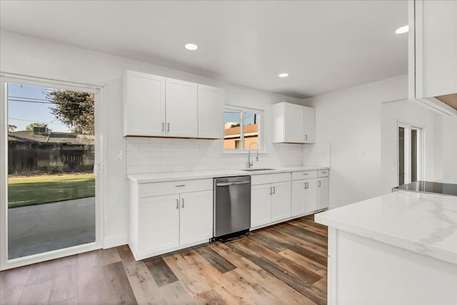 230 E Sycamore Dr, Hanford, CA 93230 - kitchen with decorative backsplash, white cabinets, a sink, light countertops, and dishwasher
