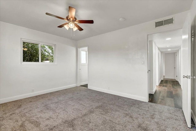 230 E Sycamore Dr, Hanford, CA 93230 - unfurnished room featuring visible vents, dark carpet, ceiling fan, and baseboards