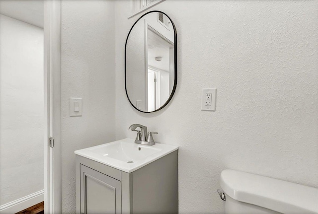 230 E Sycamore Dr, Hanford, CA 93230 - half bathroom featuring toilet, visible vents, and vanity